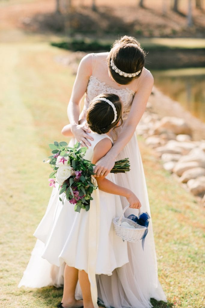 Bride holds flower girl