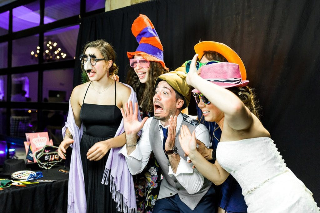 Wedding guests pose in photo booth