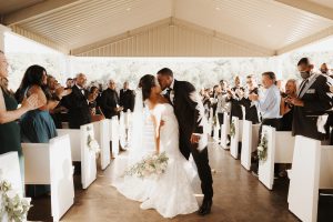 Bride and Groom kiss in chapel aisle